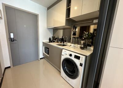 Modern kitchen with built-in appliances and washing machine