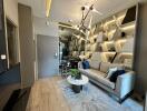 Modern living room with a sofa, decorative shelving, and contemporary lighting