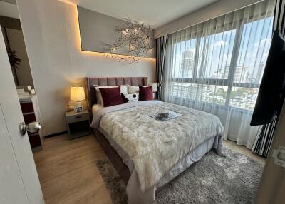 Cozy bedroom with decorations and city view