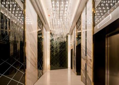 Luxurious building lobby with chandeliers and elevators