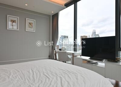 Spacious bedroom with large window and city view