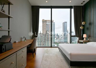 Modern bedroom with large city view windows