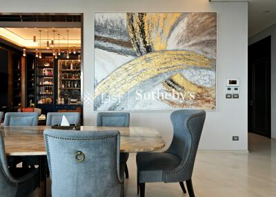 Elegant dining area with modern art and well-furnished interiors