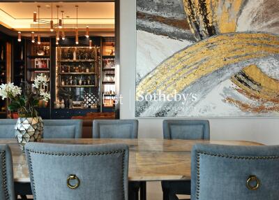 Contemporary dining room with art piece and stylish chandelier