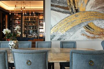 Contemporary dining room with art piece and stylish chandelier