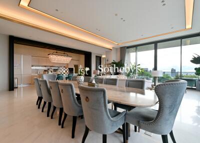 Spacious and modern open-plan living and dining area with large windows and balcony view