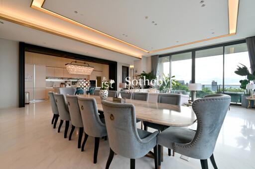 Spacious and modern open-plan living and dining area with large windows and balcony view