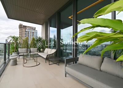 Spacious balcony with modern outdoor furniture and city view