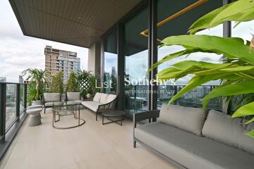 Spacious balcony with modern outdoor furniture and city view