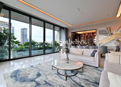 Spacious modern living room with large windows and city view