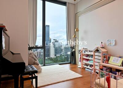 Bedroom with large window and city skyline view