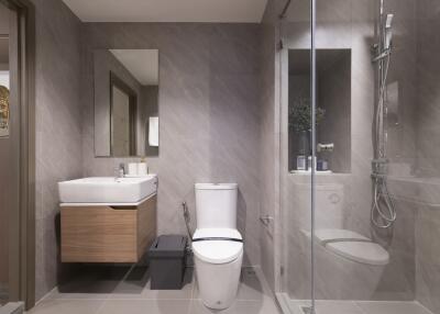 Modern bathroom with a glass shower, toilet, and sink with a mirror