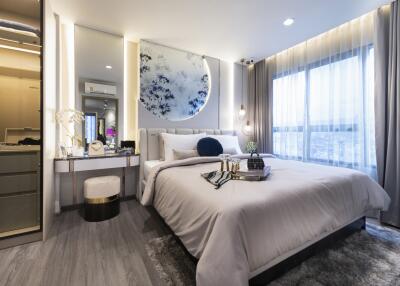 Modern bedroom with large bed, decorative wall piece, vanity, nightstands, and large windows