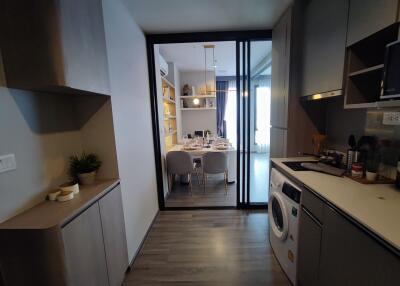 Stylish modern kitchen leading to a dining area through sliding glass doors