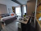 Modern studio apartment with bed, dining area, and living space