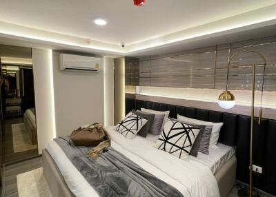 Modern bedroom with double bed, stylish decor, and ambient lighting