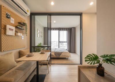 Modern apartment with dining area, sliding doors, and a bedroom