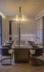 Modern dining room with stylish chairs and glass table.