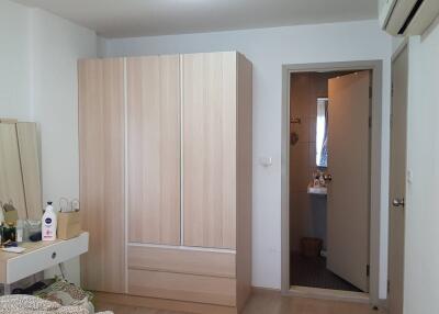 Spacious bedroom with wardrobe and adjacent bathroom