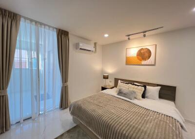 Modern bedroom with bed, curtains and wall art