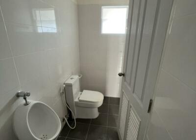 Small bathroom with urinal and toilet