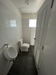 Small bathroom with urinal and toilet