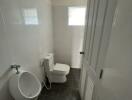 Small bathroom with urinal and toilet