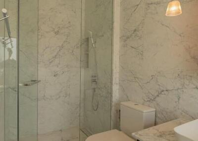 modern bathroom with glass shower and marble tiles