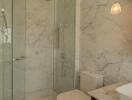 modern bathroom with glass shower and marble tiles