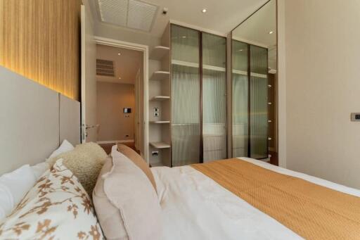 Modern bedroom with large bed and built-in wardrobe