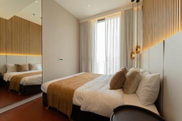 Modern bedroom with double bed and decorative lighting