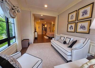 Bright and elegant living room with white furniture and framed artwork