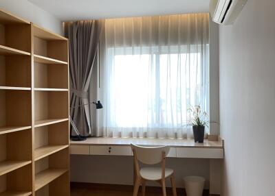 Well-lit bedroom with a study desk