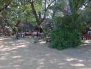 Beachfront property with huts and lush greenery