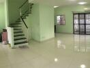 Spacious living room with tiled floors and a staircase