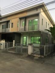 Front view of a modern townhouse with a gated entry