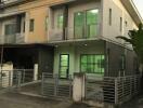 Front view of a modern townhouse with a gated entry