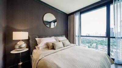 Modern bedroom with large windows and city view