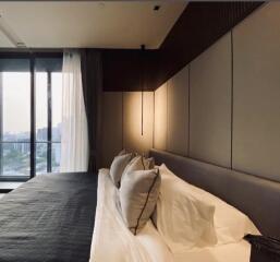 Modern bedroom with large bed and window view