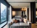 Modern bedroom with a city view, stylish grey couch, well-lit interior and floor-to-ceiling windows