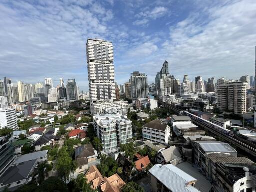 Panoramic view of a city with high-rise buildings and greenery