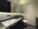 Modern bathroom with marble countertop and wall-mounted toilet