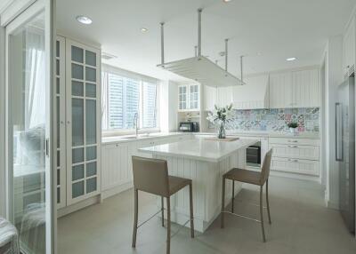 Modern white kitchen with island and stools