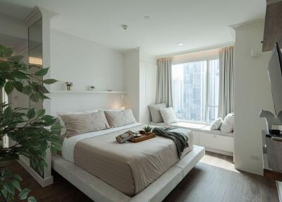 Modern bedroom with large window and city view