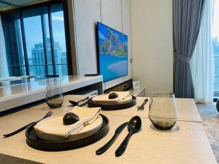 Modern dining area with table setting and large window view