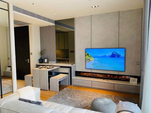 Modern living room with wall-mounted TV and electric fireplace