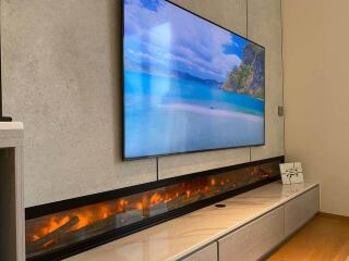 Modern living room with wall-mounted TV and sleek fireplace