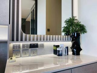 Modern vanity setup with marble countertop and decorative elements