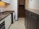 Modern kitchen with appliances and adjacent stairway