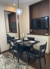 Contemporary dining area with a wall-mounted TV